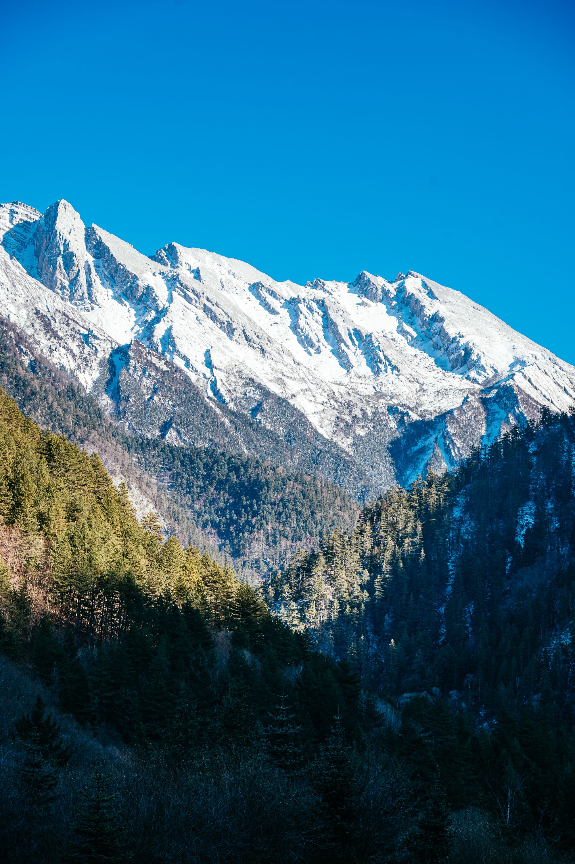 Snow-Capped Mountain Peaks Under Clear Blue Sky · Free Stock Photo