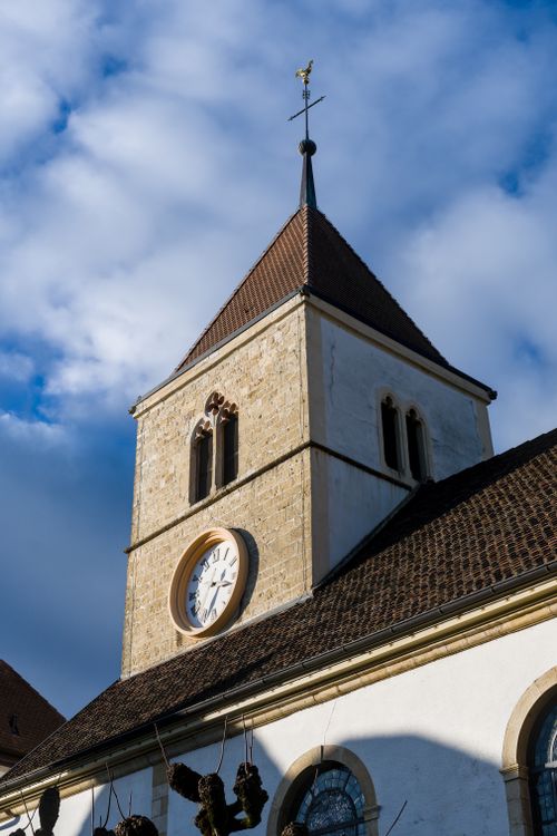 Free A scenic view of a classic church tower, highlighting its architectural design against a vibrant cloudy sky. Stock Photo