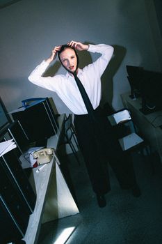 Unconventional office scene with striking fashion and dramatic lighting.
