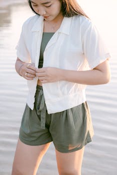 Young woman wearing casual summer attire by the serene waterside.