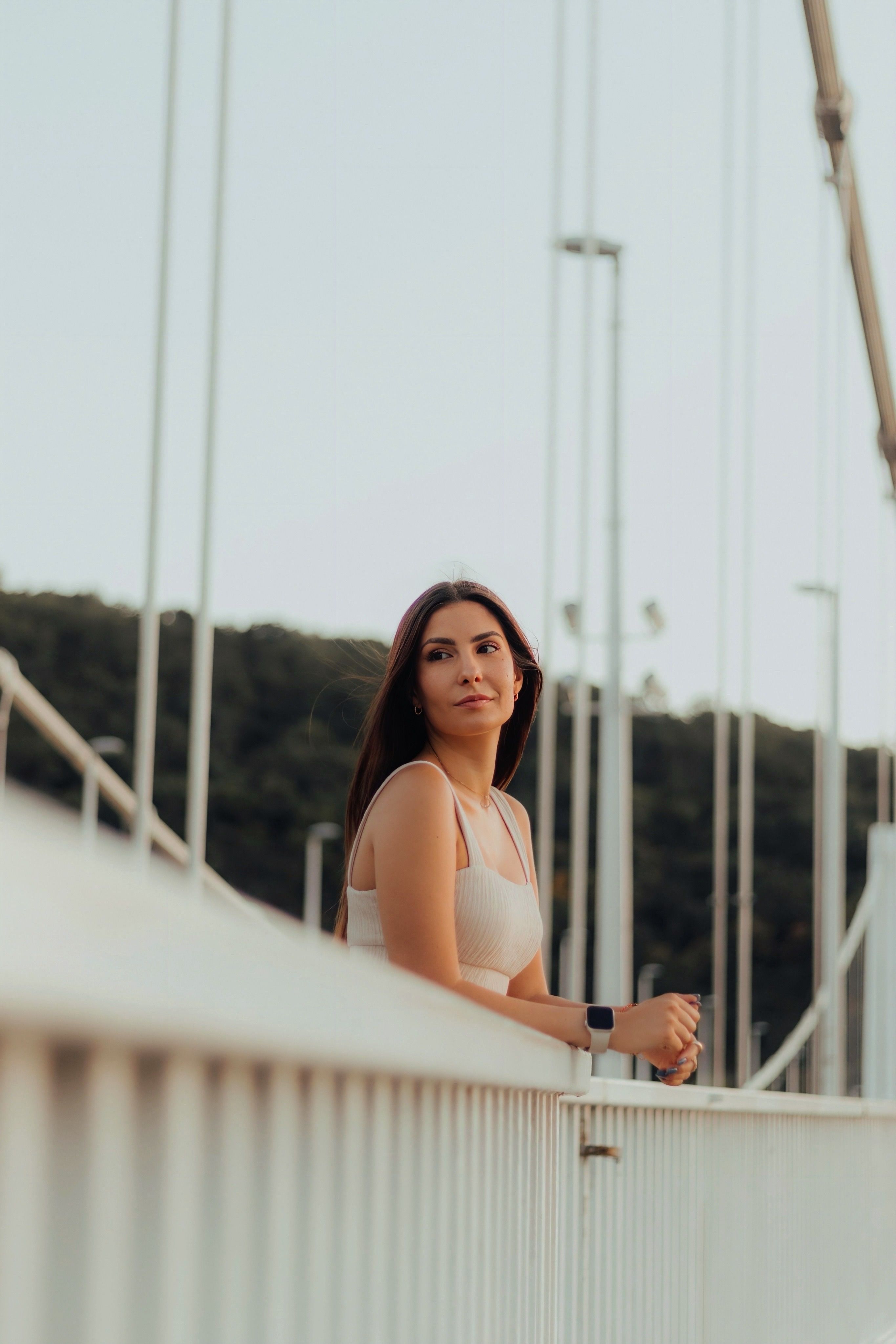 Woman Relaxing on Bridge at Sunset · Free Stock Photo