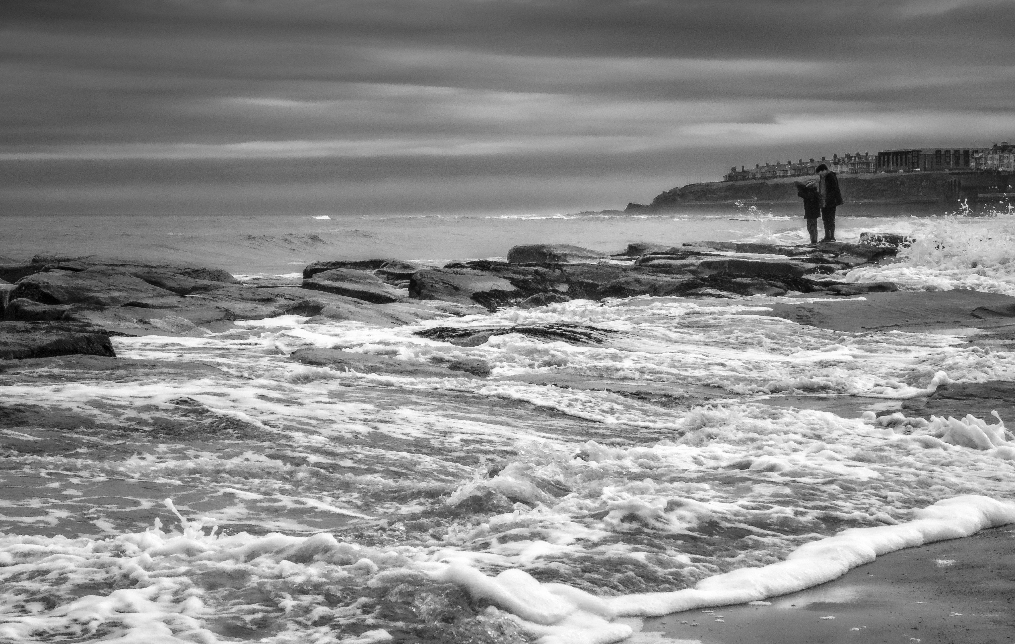 Black and White Coastal Landscape with People · Free Stock Photo