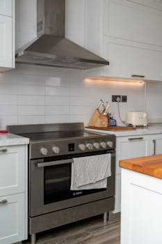 Contemporary kitchen with stainless steel appliances and minimalist decor in a Dubai apartment.