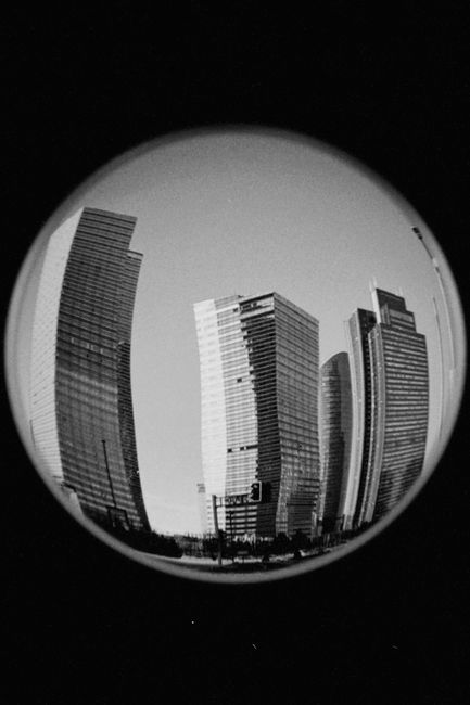 Black and white fish-eye view of modern skyscrapers in Astana, Kazakhstan.