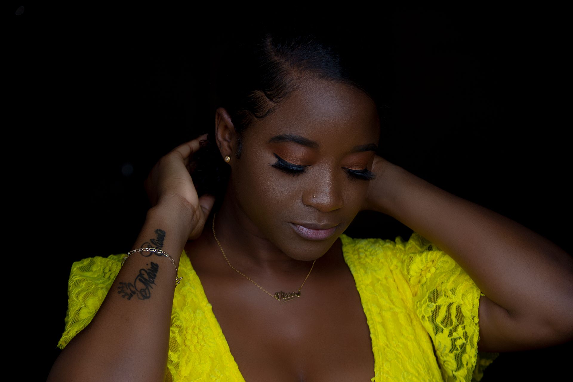 Woman Wearing Yellow Top Holding Hair
