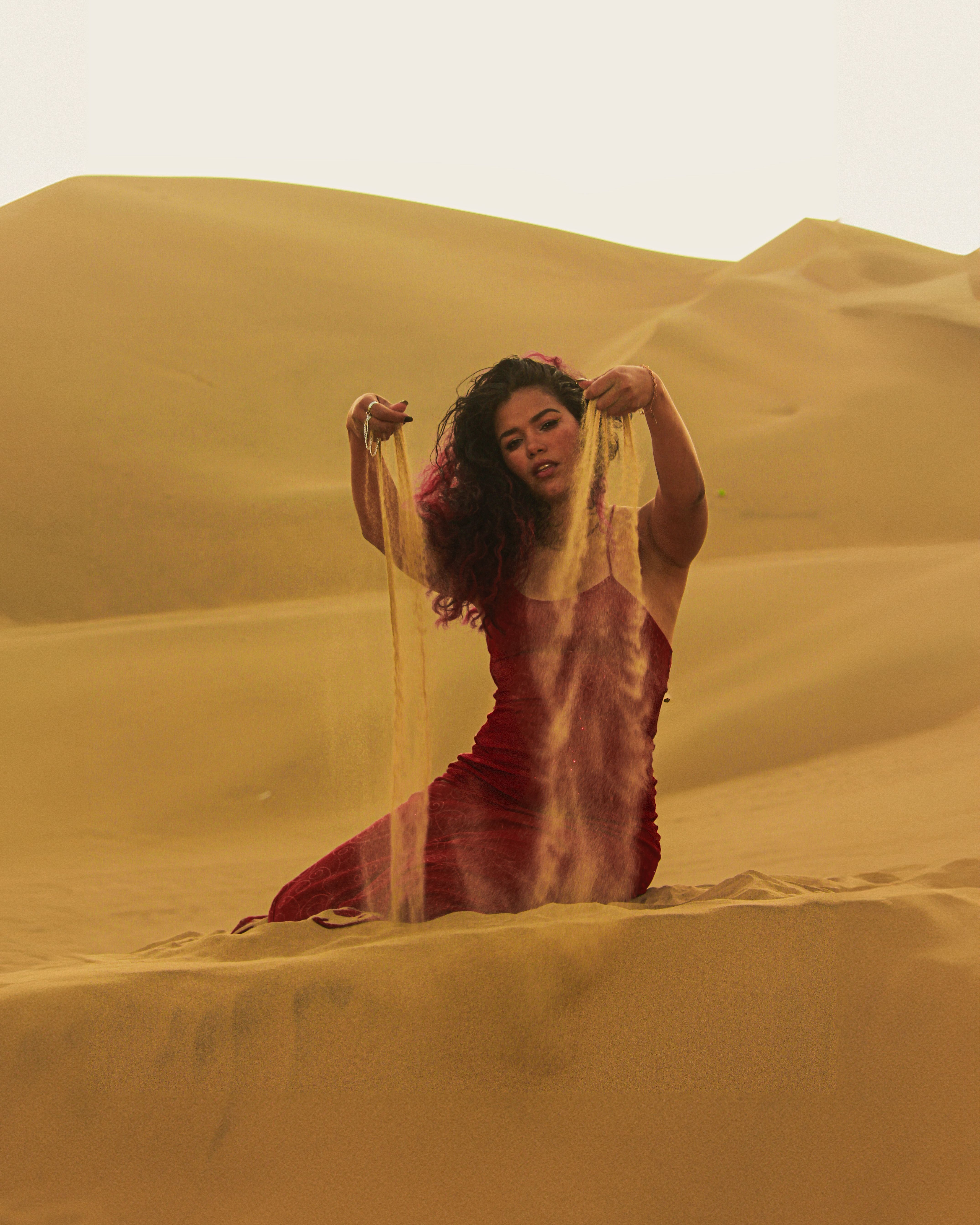 Woman in Red Dress in Desert Landscape  Free Stock Photo