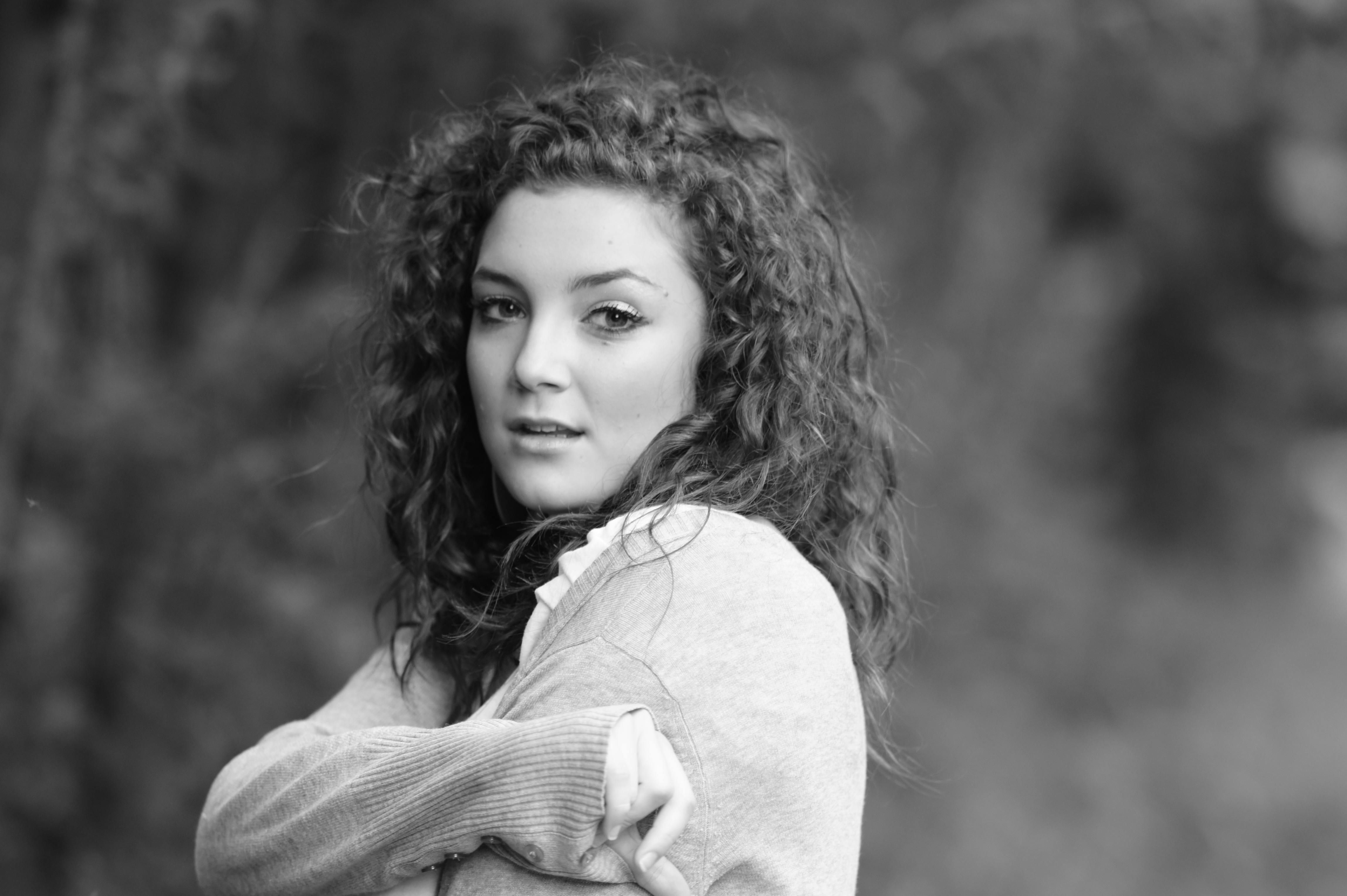 Portrait of Woman with Curly Hair in Black and White · Free Stock Photo