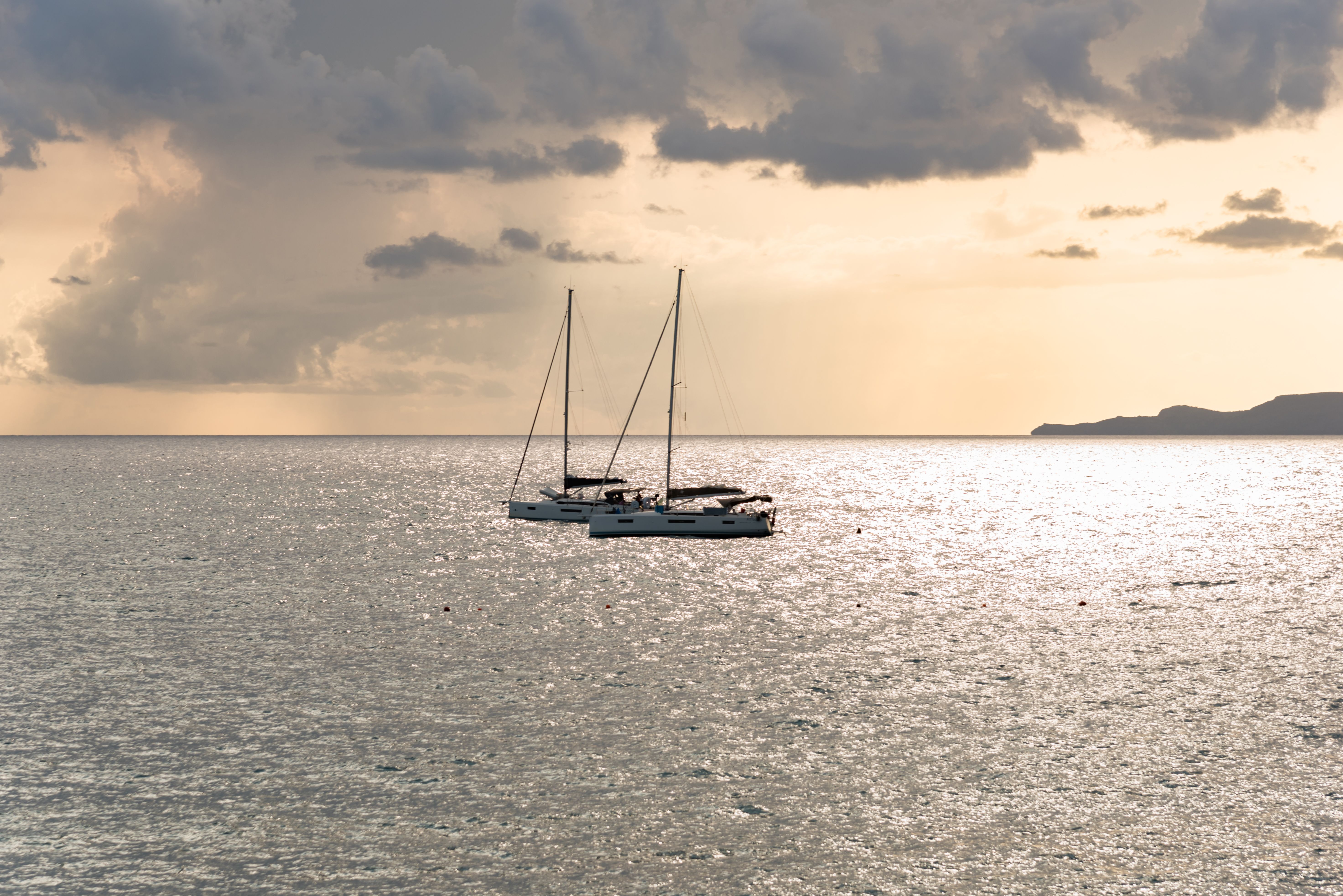 Best Capri Shared Tour: Caves, Dives, Limoncello and Caprese Cake Review 2026 - Two yachts gently sail on the shimmering waters at sunset in Maratea, Italy's stunning coastline.