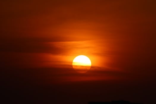 A mesmerizing and fiery sunset fills the sky with vibrant orange hues, creating a breathtaking view.