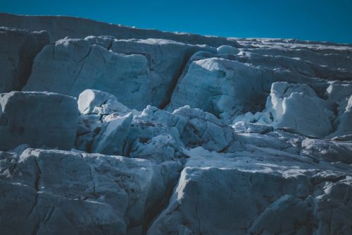 Free Captivating view of bluish ice formations set against a clear blue sky, embodying winter's chill. Stock Photo