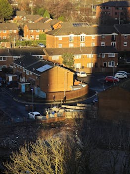 Aerial view of a sunny urban neighborhood with brick houses.