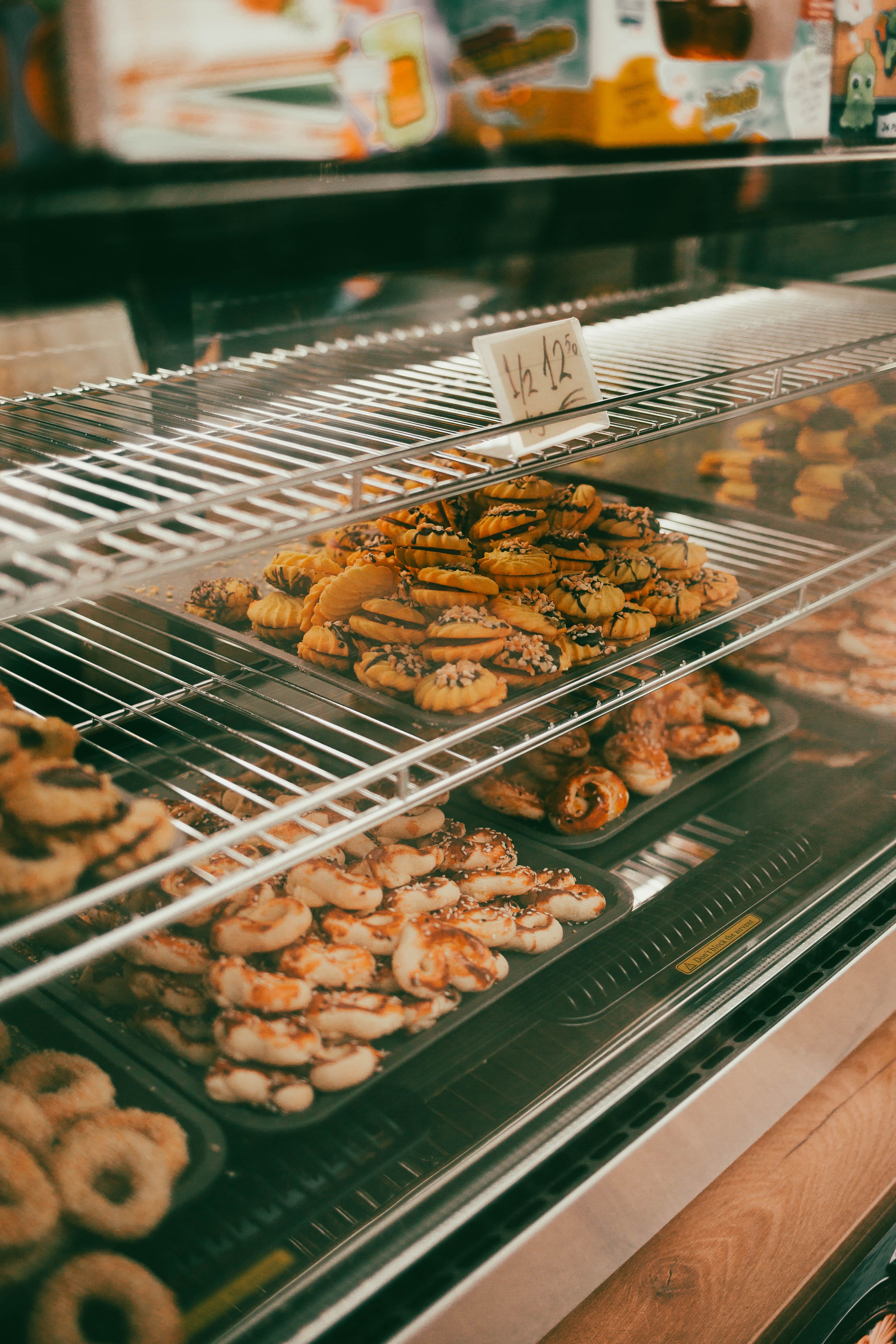 A tempting assortment of cookies in a Vienna bakery shop window display, showcasing variety and freshness.