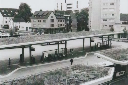 Free A city bus station with modern design and people waiting on platforms. Stock Photo
