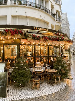 Cozy Paris café Le Compas with festive decorations and bustling atmosphere.