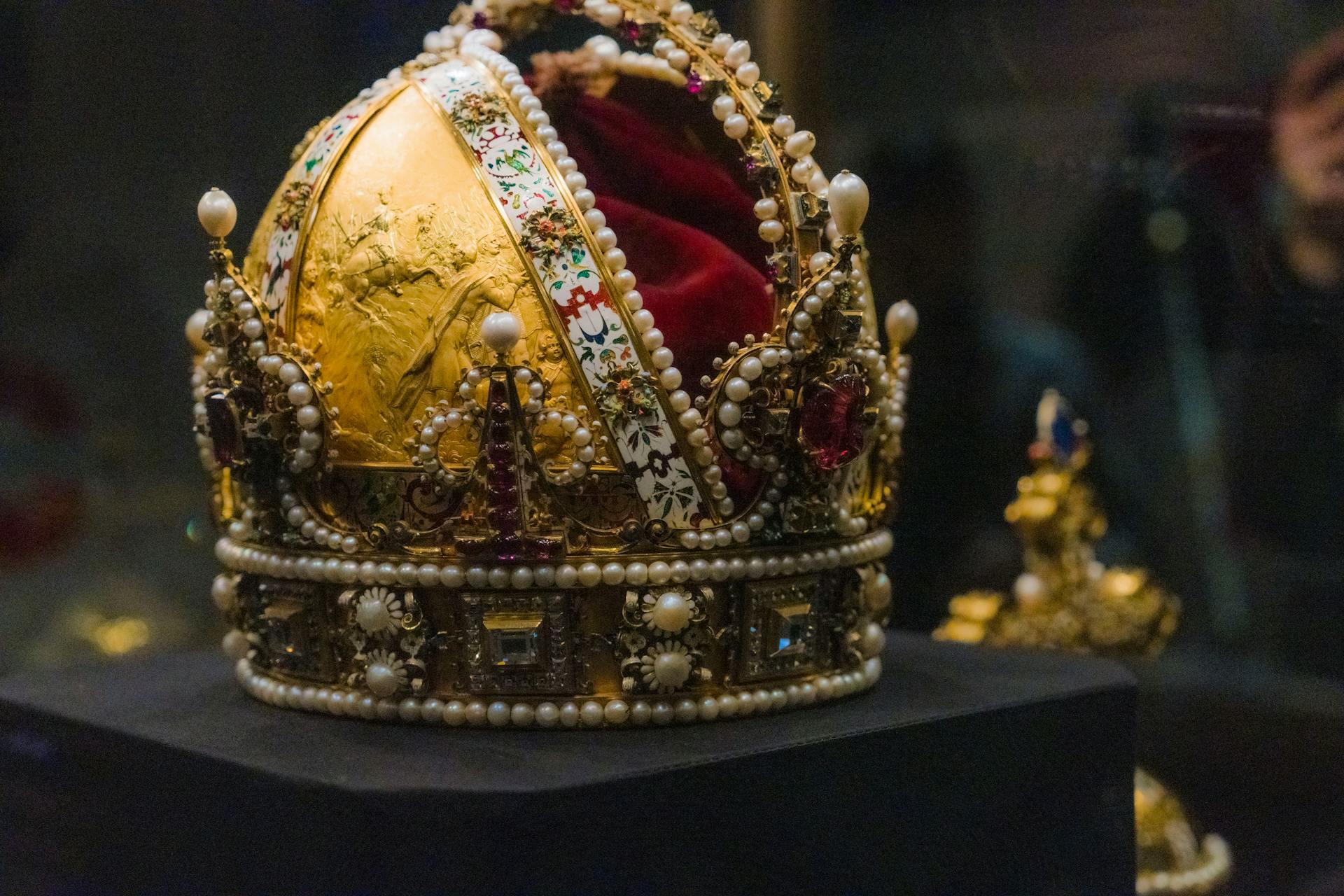 Majestic imperial crown displayed in a Vienna museum, showcasing intricate design and rich history.