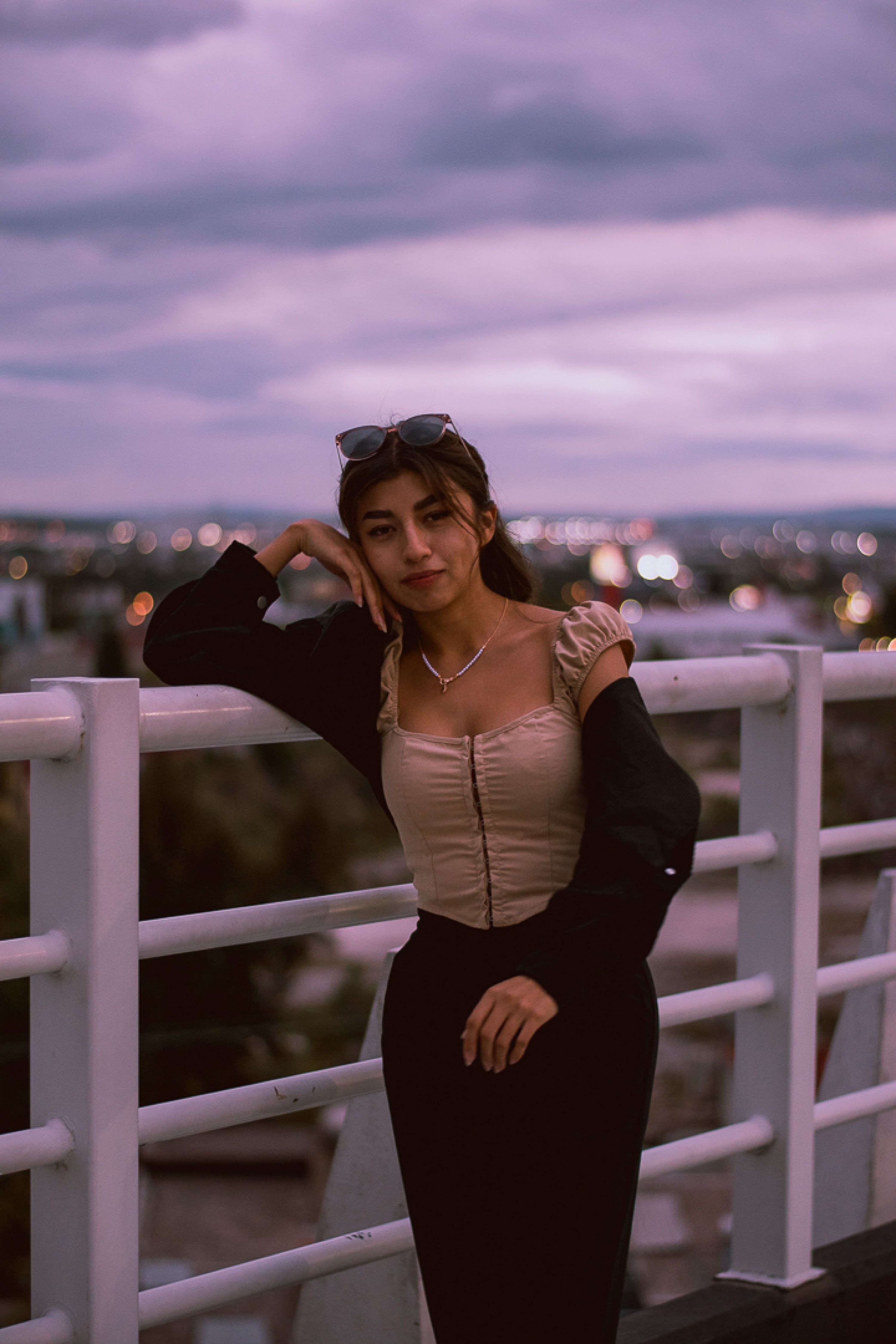 Stylish Woman Posing at Sunset Overlooking City · Free Stock Photo