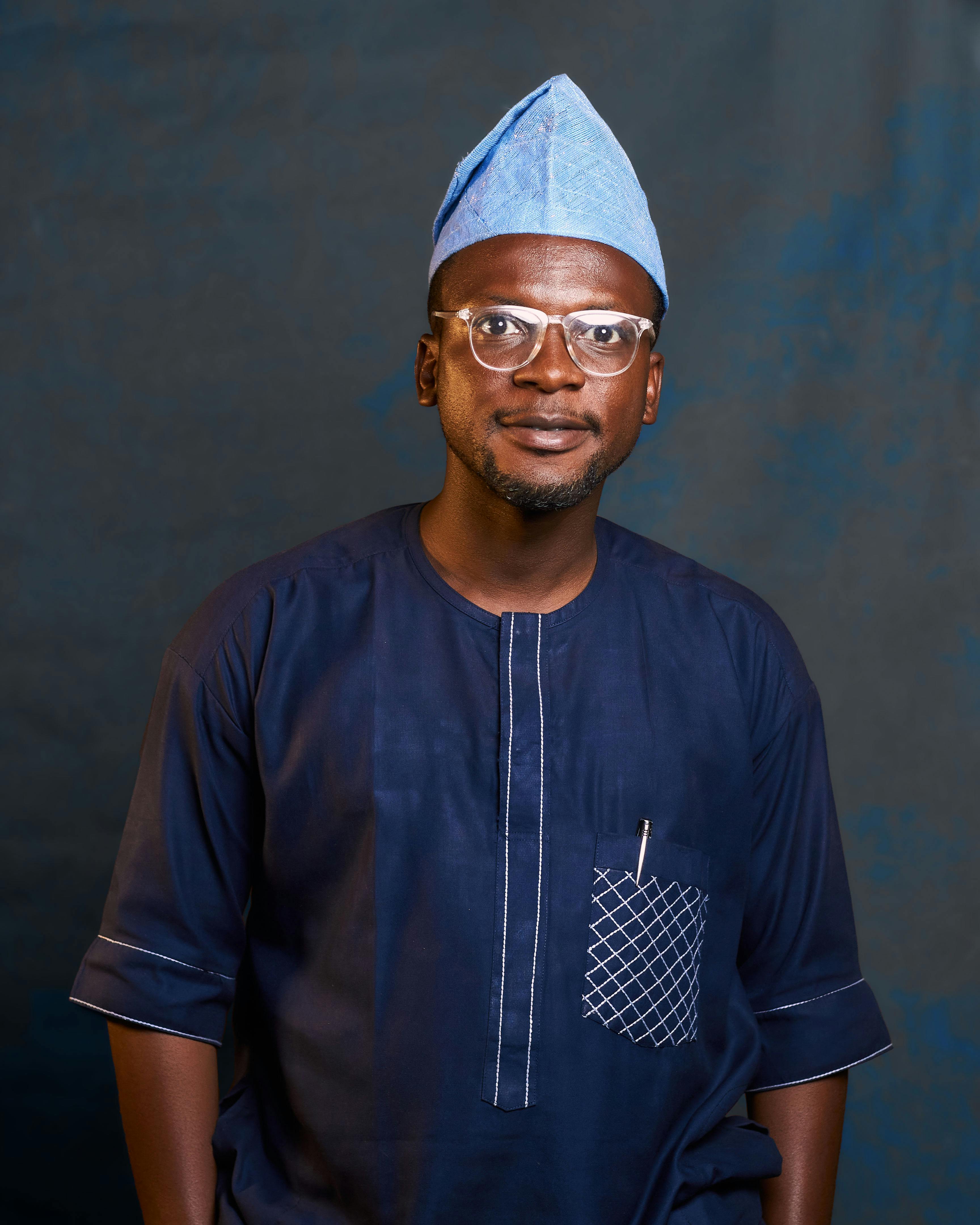 Man wearing traditional Nigerian attire with a confident pose.