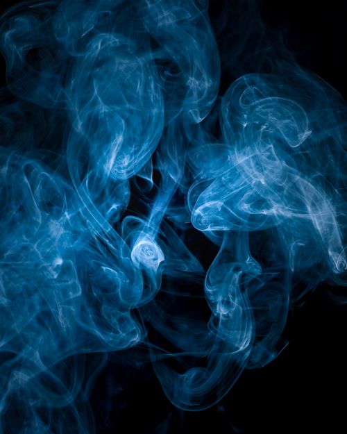 Free Vibrant blue smoke art swirling elegantly against a dark backdrop. Stock Photo