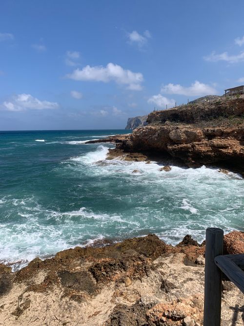 Free Captivating coastal landscape showcasing rocky shores and vibrant blue waters in Dénia, Spain. Stock Photo