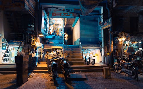 Three Motorcycle Park Near Shop during Nighttime