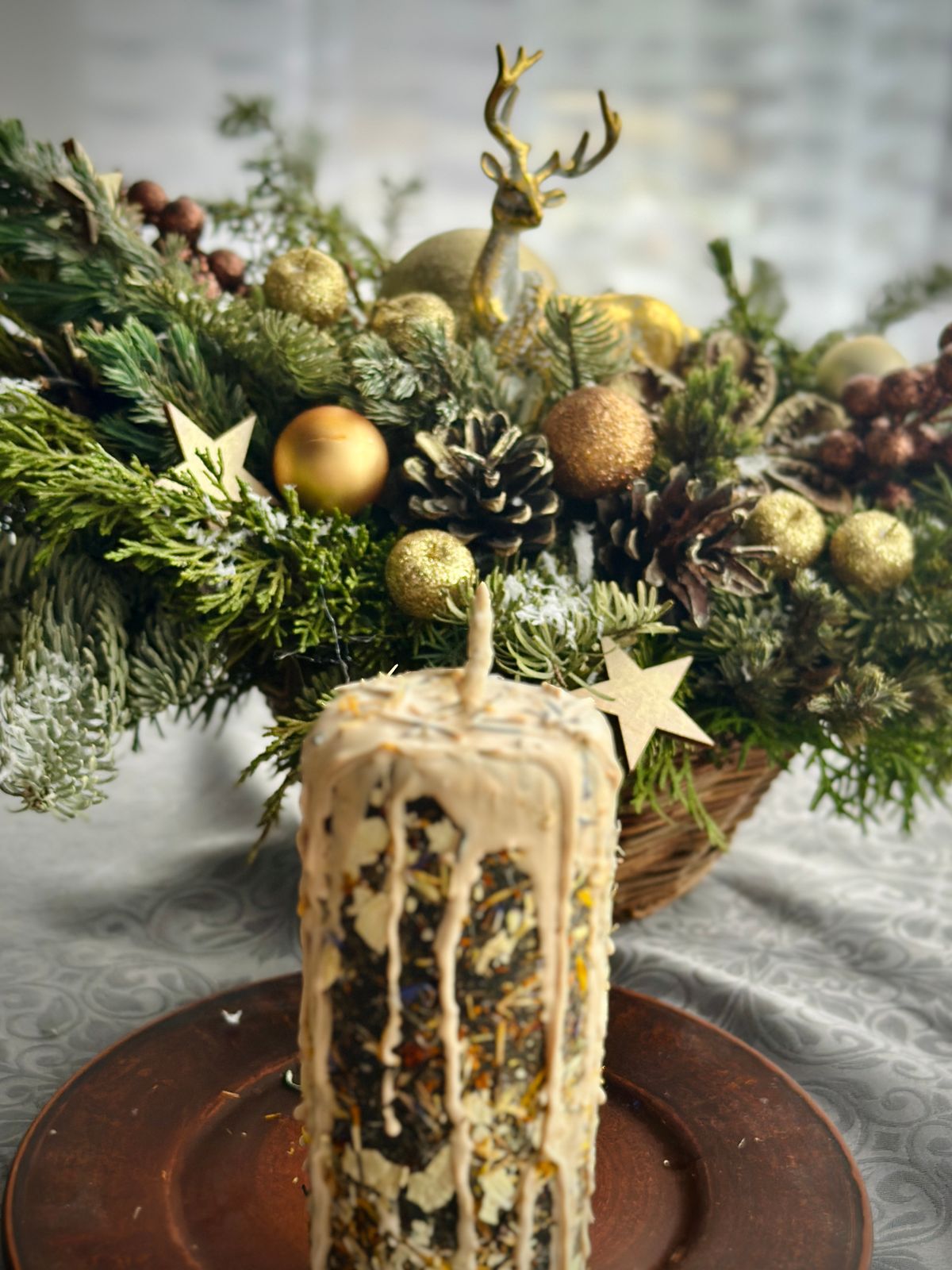Holiday candle with pine and bauble arrangement for Christmas centerpiece ideas