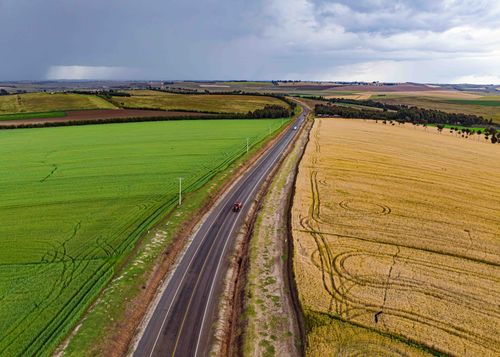 Free Scenic aerial view of a rural road between fields in Mau Narok, Kenya. Perfect for travel and nature themes. Stock Photo