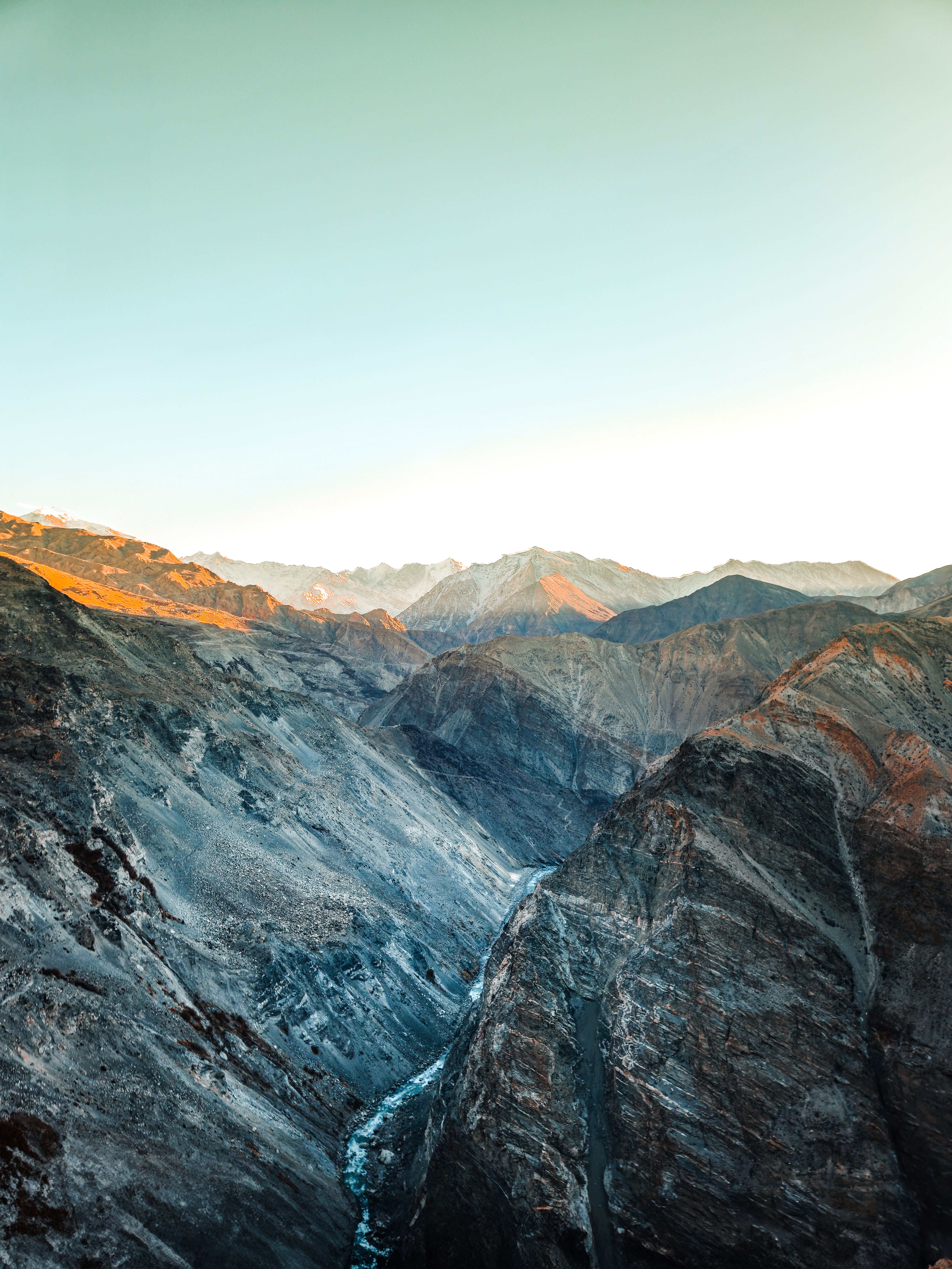 A breathtaking view of snow-capped mountains in Spiti Valley at sunrise.
