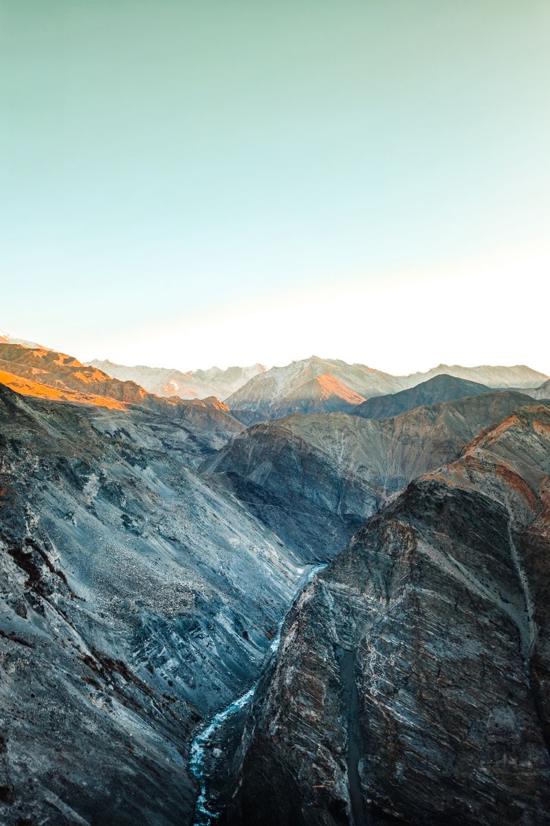 A breathtaking view of snow-capped mountains in Spiti Valley at sunrise.