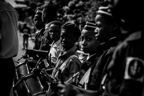 Free A black and white photo of young drummers at a parade, capturing a vivid street scene. Stock Photo