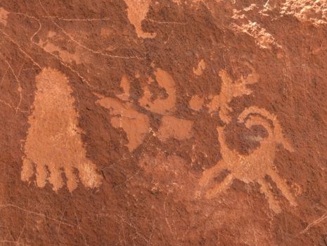 Detailed view of ancient petroglyphs on sandstone in Nevada desert.