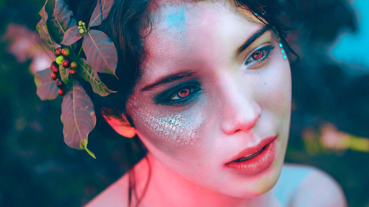 artistic portrait of a woman with unique makeup and leaf headdress evo
