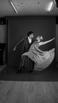 Classic black and white portrait of dancers striking a graceful pose indoors.