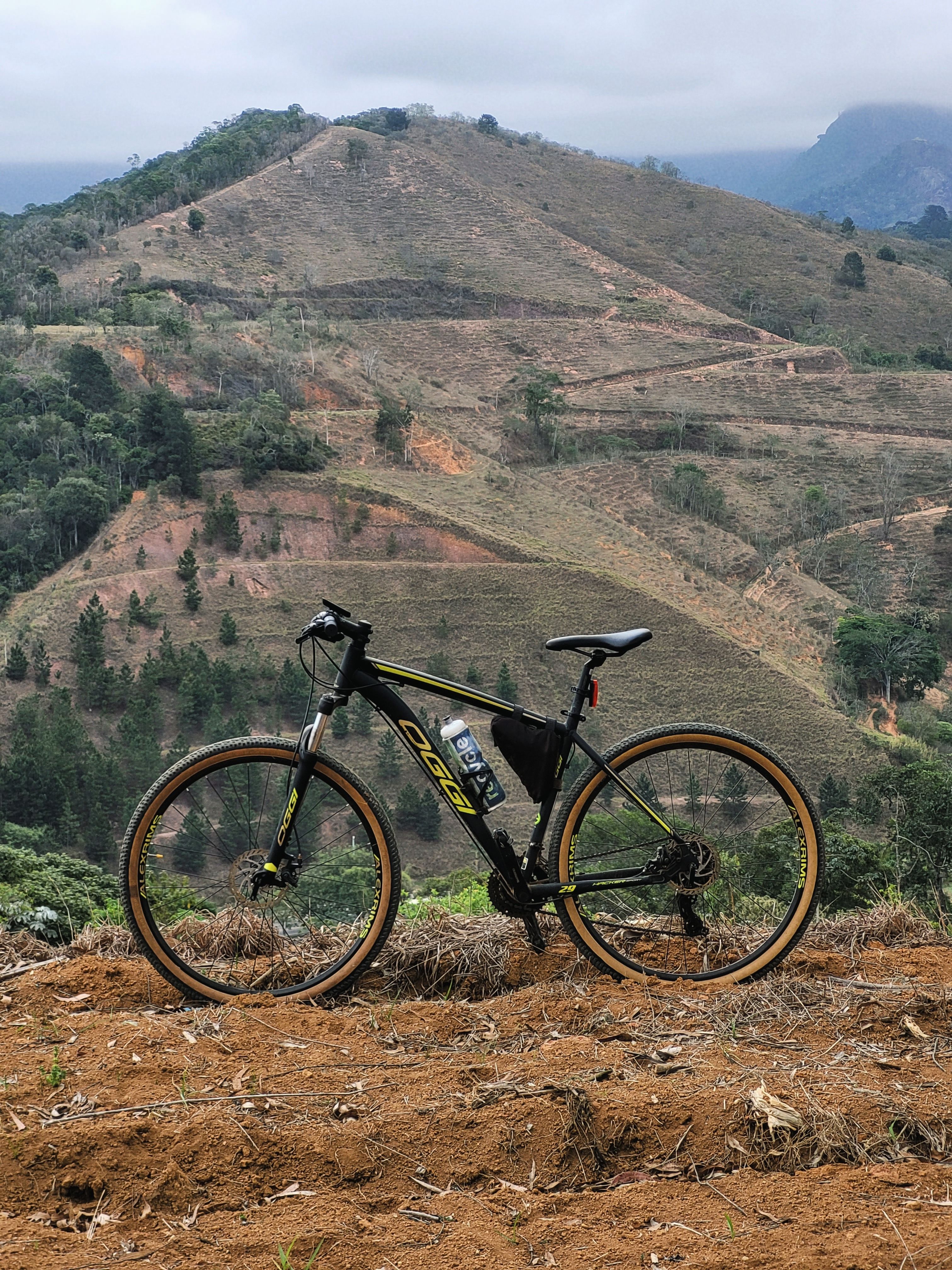 Mountain bike on a rugged trail with scenic hillside backdrop, ideal for outdoor enthusiasts.
