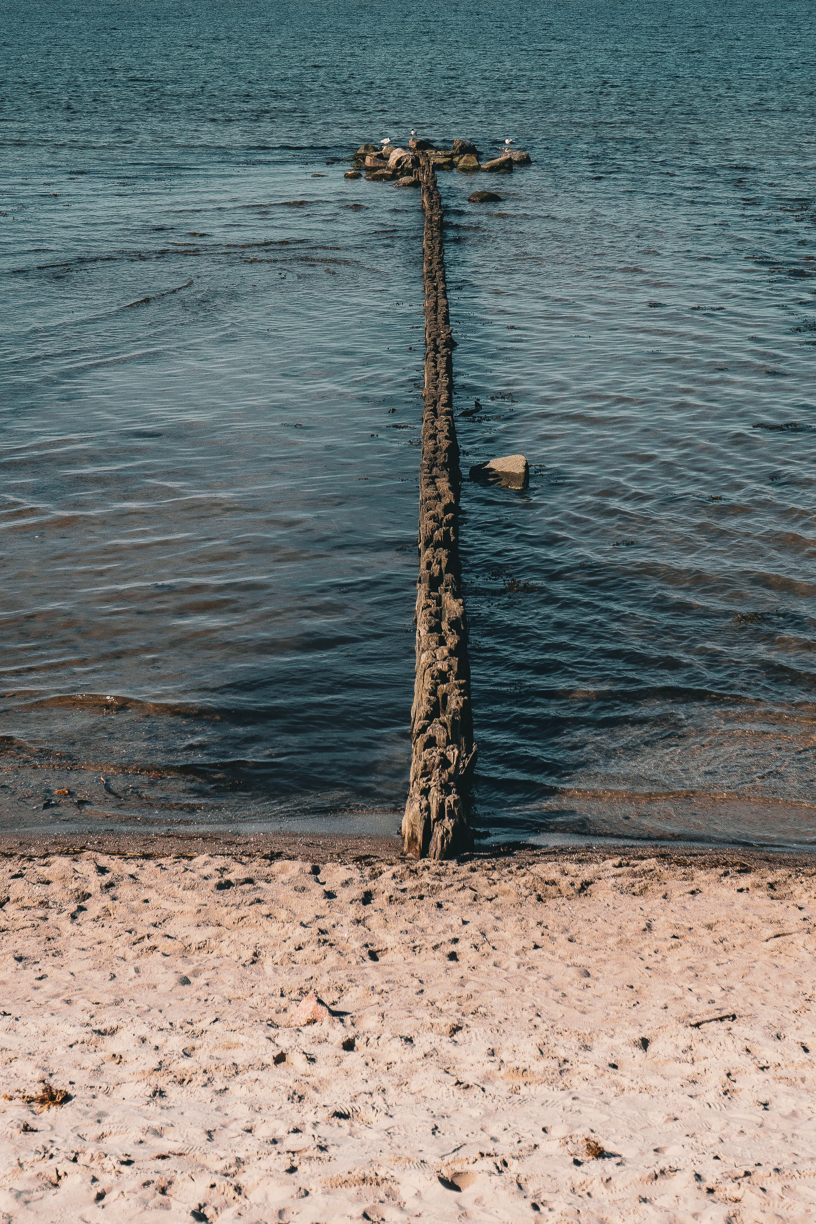 Visual Reference: Rustic Wooden Pier Extending Into Calm Sea Waters