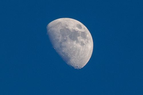 Free Crisp photo of the waxing gibbous moon against a clear blue sky over Quy Nhơn, Vietnam. Stock Photo