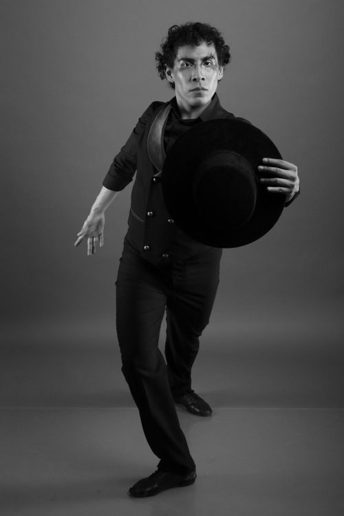 Free Expressive black and white photo of a male dancer in motion holding a hat. Stock Photo