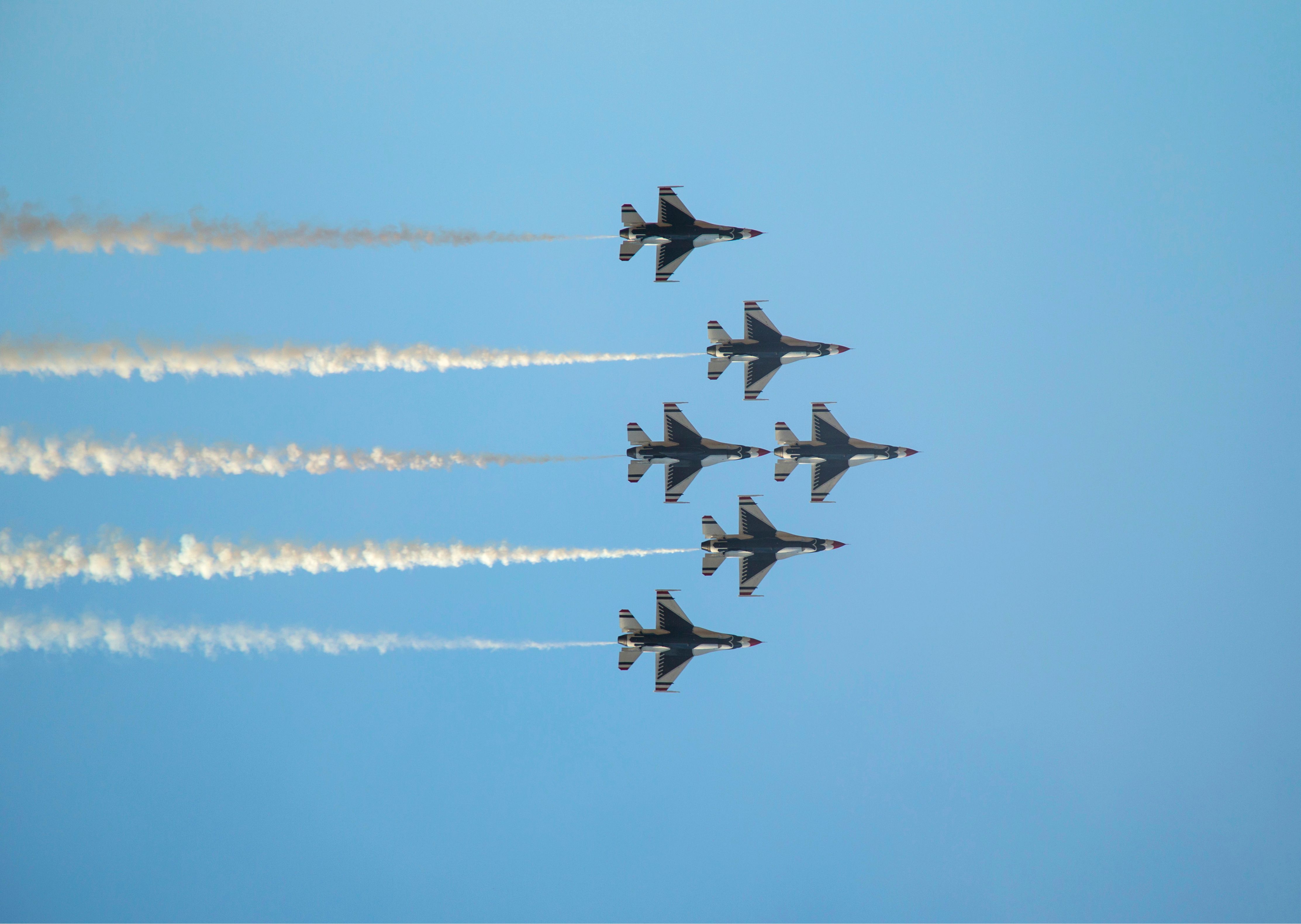 Aerobatic Fighter Jet Formation Against Blue Sky · Free Stock Photo