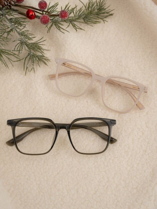 Free Stylish glasses set on cozy fabric with festive green foliage and berries. Stock Photo
