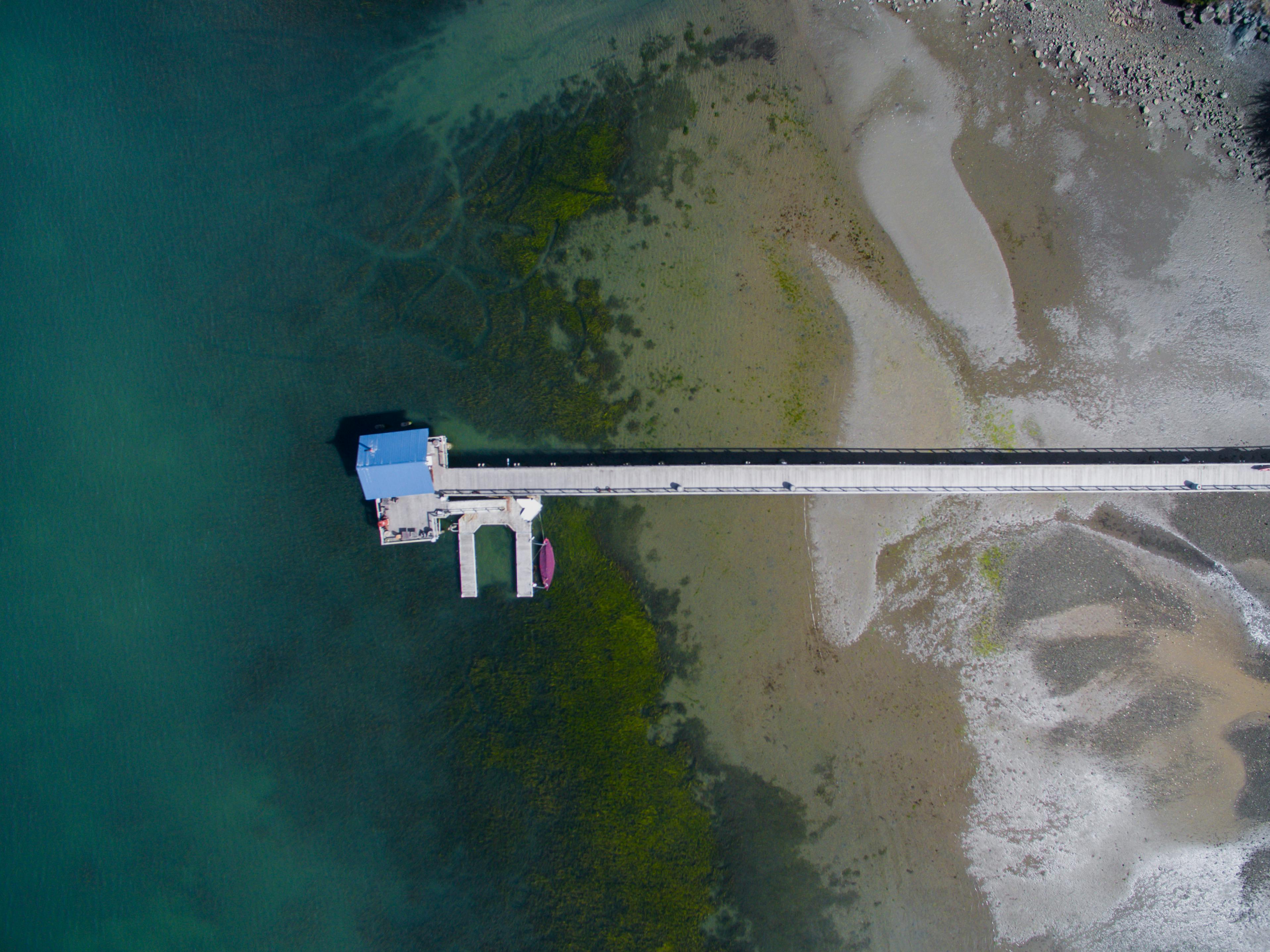 A stunning aerial view of a pier extending into the ocean at Point Reyes, California.