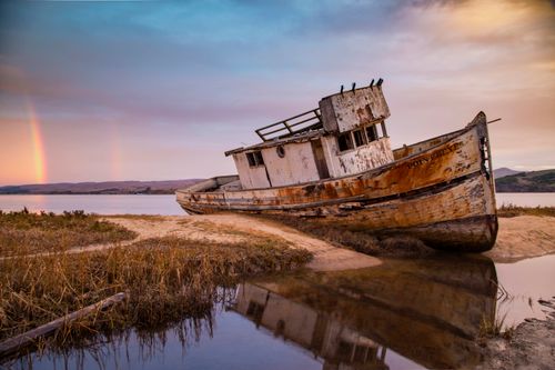 Free Photo of a vintage shipwreck at Point Reyes, California with a beautiful sunrise and rainbow Stock Photo