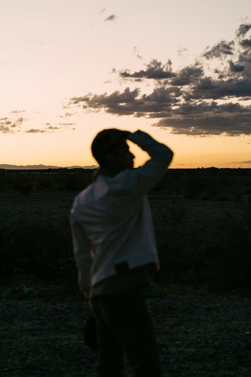 Free Photo of Man Standing Outdoors During Golden Hour Stock Photo