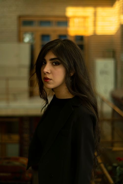 Free Side profile portrait of a woman with long black hair in a stylish setting. Stock Photo