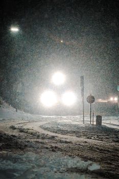 A train emerges through heavy snow at night in Lilienfeld, Austria, creating a dramatic winter scene.
