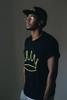 一名非洲男子在室内穿着休闲装摆姿势，展现出轻松的风格