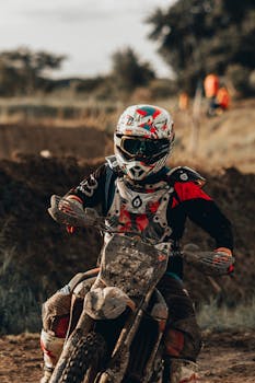 A motocross rider speeding on a dirt track, showcasing action and adrenaline.