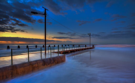 Breathtaking seascape view of pier at twilight with vibrant colors.