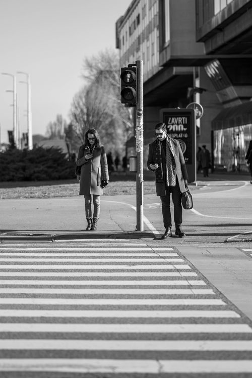Free People waiting at a crosswalk in Zagreb, captured in a black and white street photograph. Stock Photo