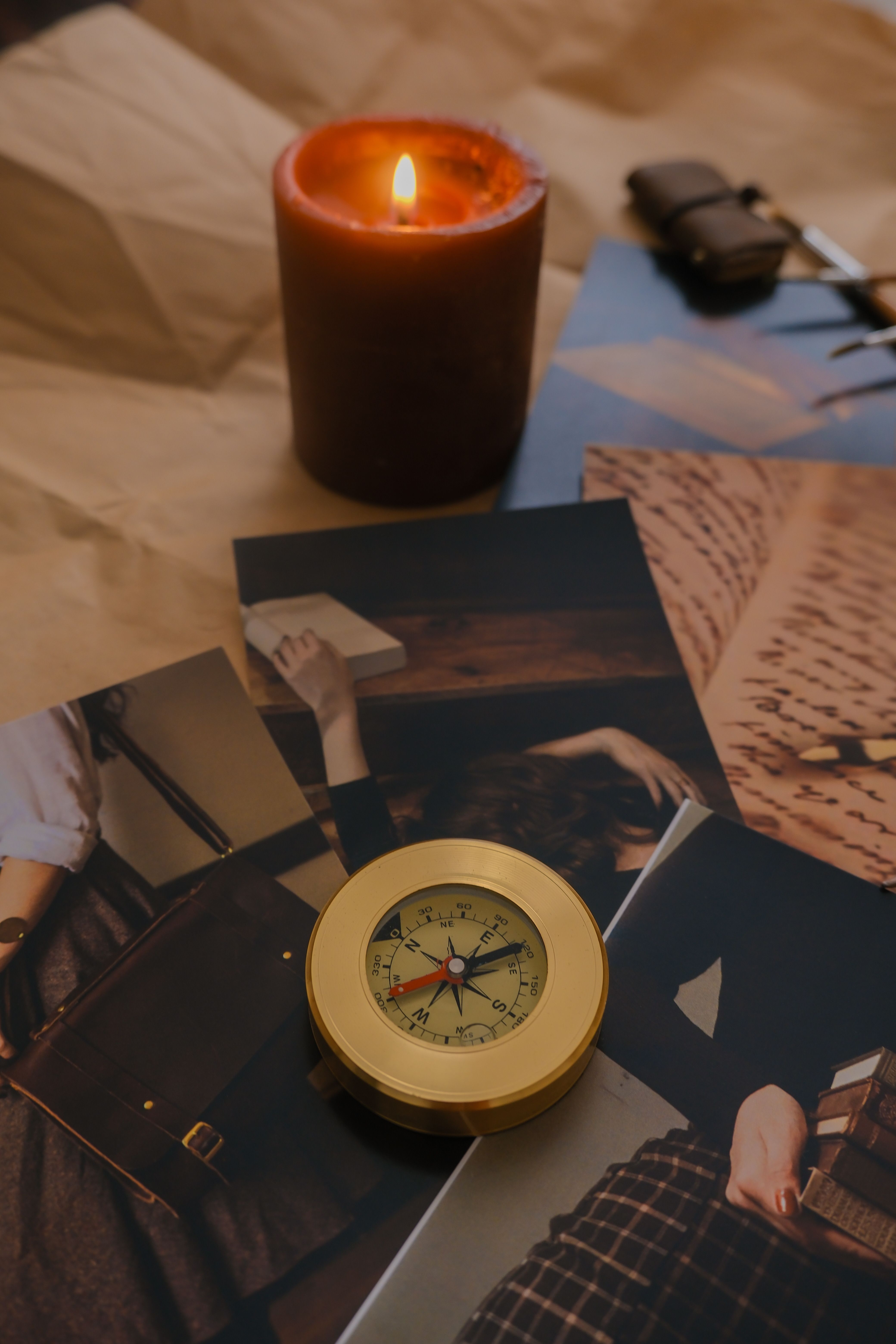 Brass pocket compass on prints — photo by Neil Marshall on Pexels