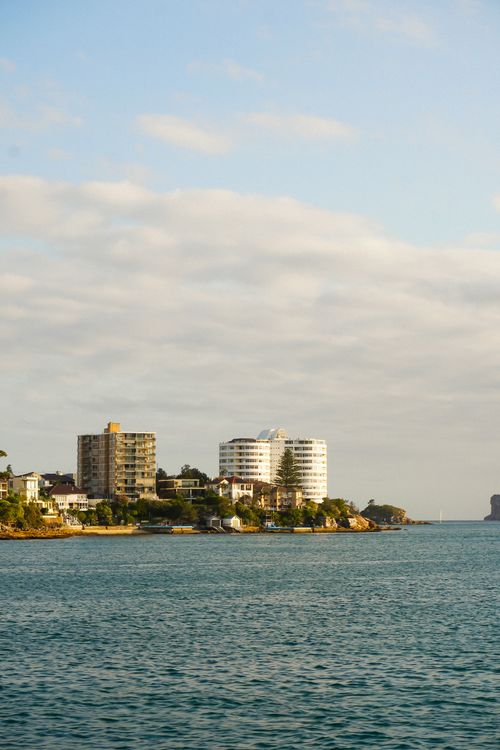 Free A coastal city view featuring modern high-rise apartments against a clear sky. Stock Photo
