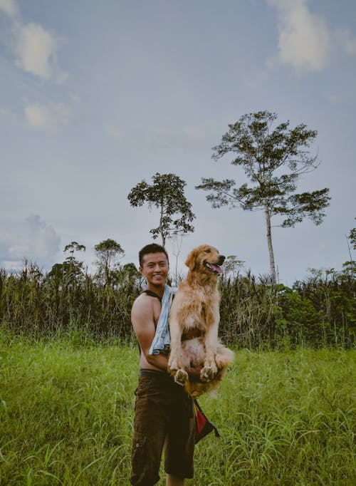 Photo Of Man Carrying Dog